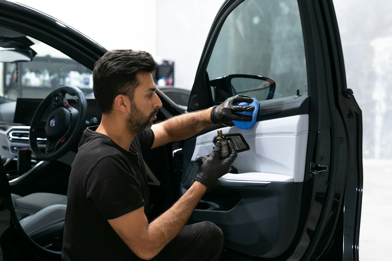 Professional detailer cleaning a real car interior